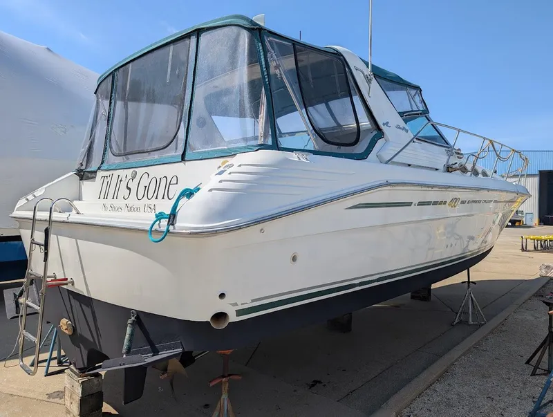Slide: The Image of 1995 Sea Ray 400 Express Cruiser on stands, featuring a covered cockpit and sleek design. - 7