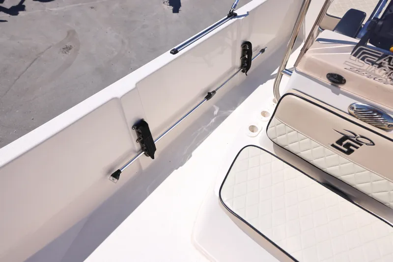 Slide: The Image of 2020 Carolina Skiff 192 JLS boat interior with cushioned seating and rod holders. - 13