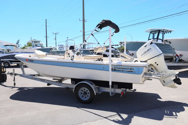 Slide: The Image of 2020 Carolina Skiff 192 JLS boat on trailer, featuring Suzuki outboard motor. - 8