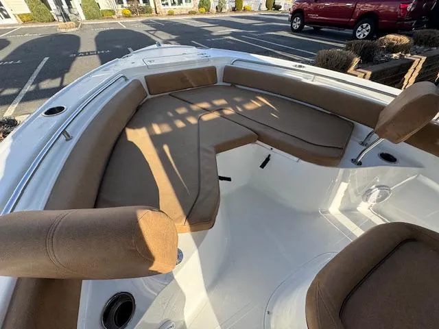 Slide: The Image of 2022 Sea Hunt Ultra 234 boat with spacious tan seating and sleek design. - 10