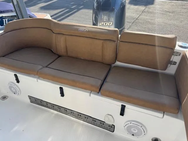 Slide: The Image of 2022 Sea Hunt Ultra 234 boat with tan cushioned seating and Yamaha 200 engine. - 11
