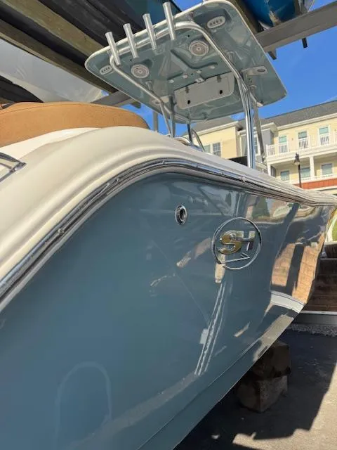 Slide: The Image of 2022 Sea Hunt Ultra 234 boat with sleek blue hull and modern design. - 12