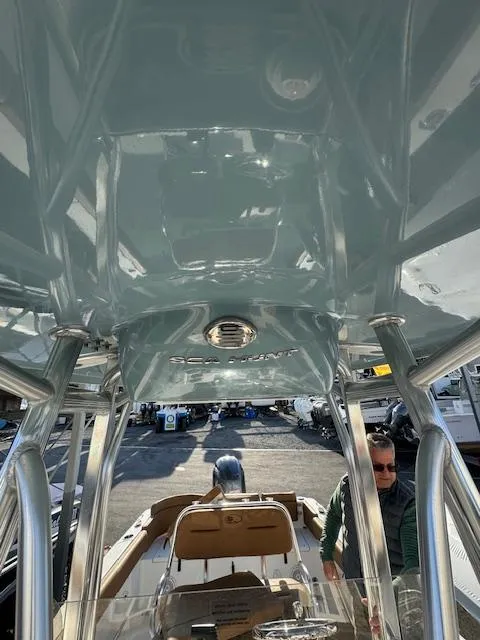 Slide: The Image of 2022 Sea Hunt Ultra 234 boat interior with console and seating. - 3