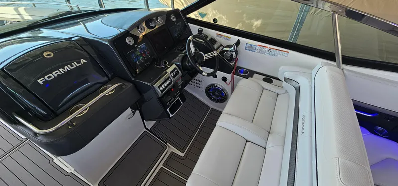 Slide: The Image of 2021 Formula 350 CBR boat interior with sleek dashboard and comfortable seating. - 12