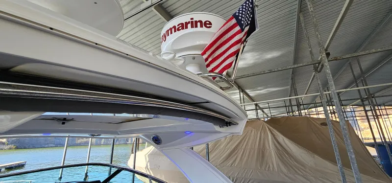 Slide: The Image of 2021 Formula 350 CBR boat docked under a canopy with an American flag. - 22