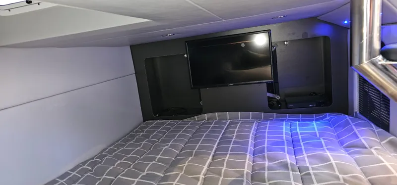 Slide: The Image of 2021 Formula 350 CBR cabin interior with bed and TV, featuring modern design and ambient lighting. - 24