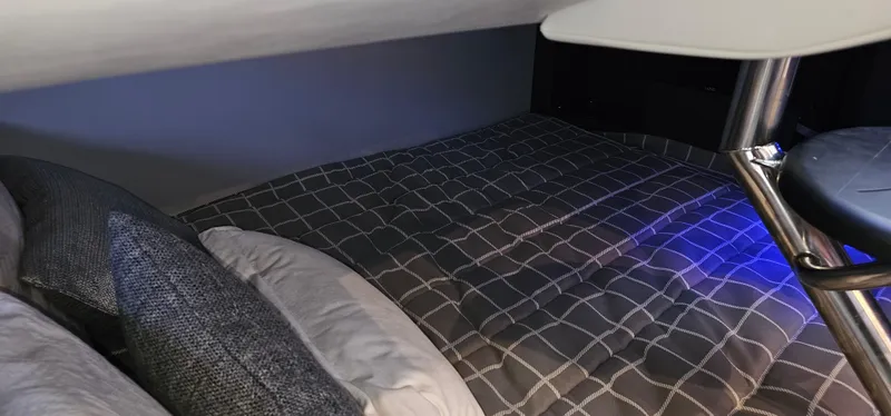 Slide: The Image of 2021 Formula 350 CBR cabin interior with cozy bedding and modern design. - 25