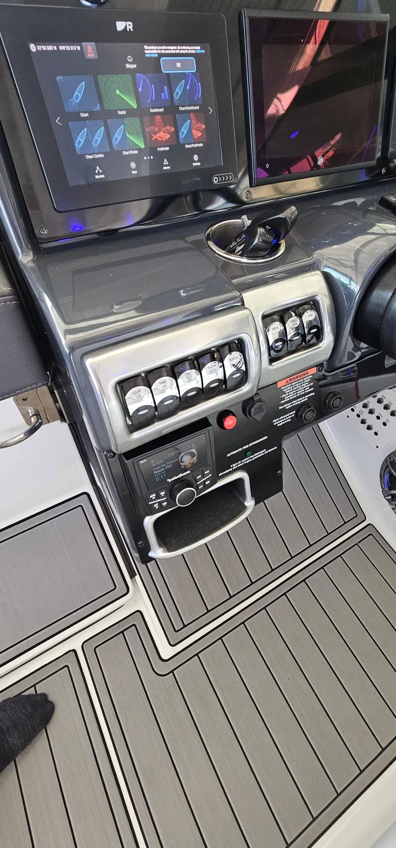 Slide: The Image of Control panel of a 2021 Formula 350 CBR boat with modern navigation screens. - 31