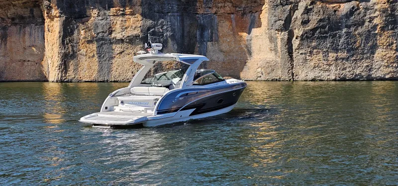 Slide: The Image of 2021 Formula 350 CBR boat cruising near rocky cliffs on a sunny day. - 38