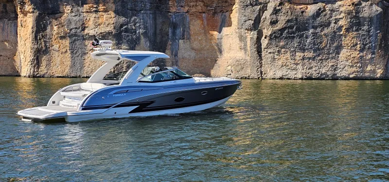Slide: The Image of 2021 Formula 350 CBR boat cruising near rocky cliffs on a sunny day. - 39