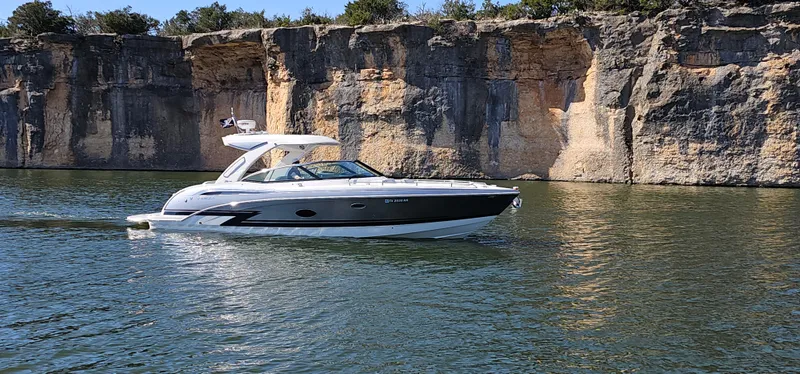 Slide: The Image of 2021 Formula 350 CBR boat cruising on a scenic lake with rocky cliffs. - 4