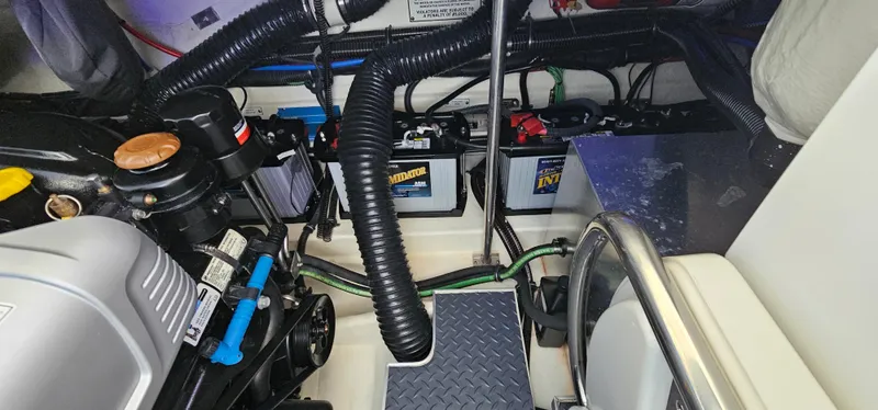 Slide: The Image of Engine compartment of a 2021 Formula 350 CBR boat, showcasing batteries and mechanical components. - 40
