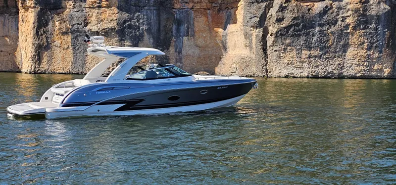 Slide: The Image of 2021 Formula 350 CBR boat cruising near rocky cliffs on a sunny day. - 41