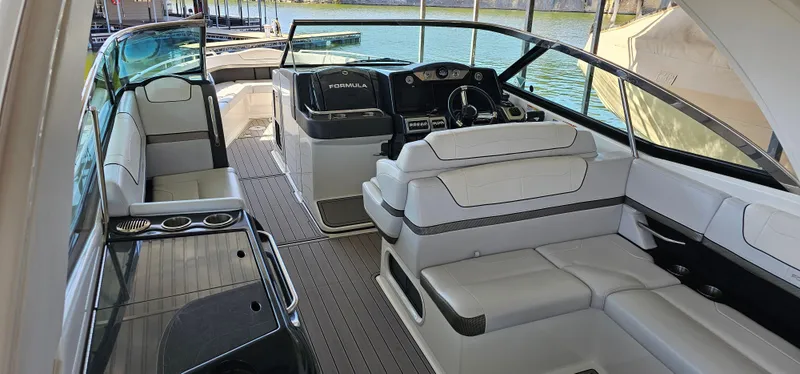 Slide: The Image of 2021 Formula 350 CBR boat interior with luxurious seating and modern dashboard. - 8