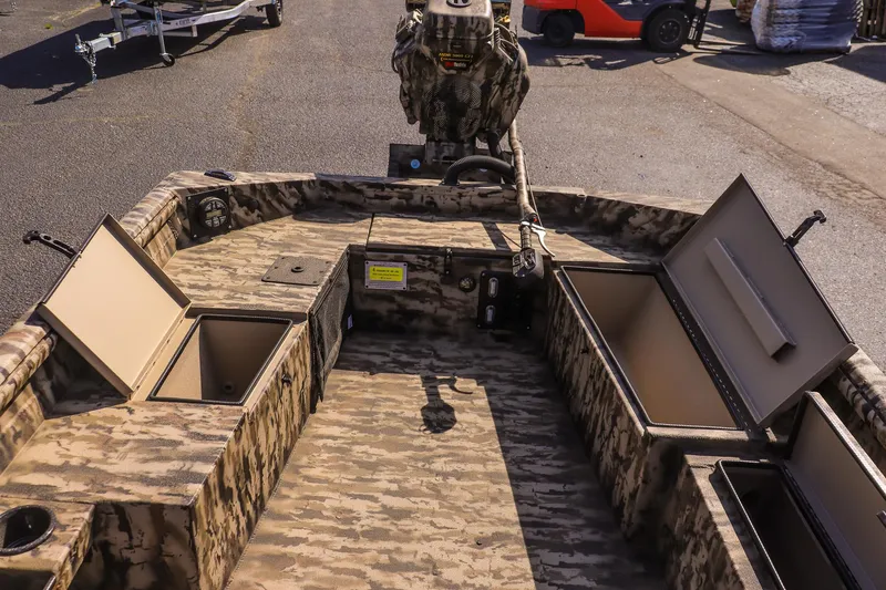 Slide: The Image of 2025 Excel 1754 F4 Shallow Water boat with open storage compartments, camo design. - 17