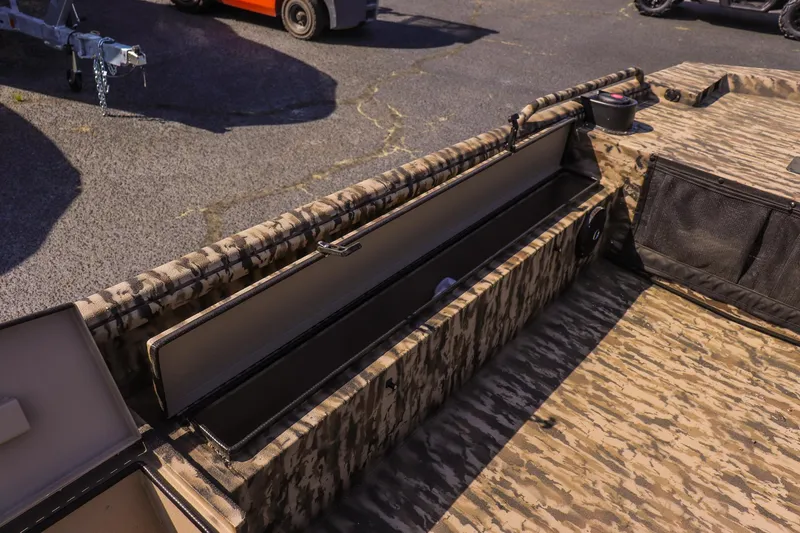 Slide: The Image of 2025 Excel 1754 F4 Shallow Water boat interior with camo design and storage compartments. - 18