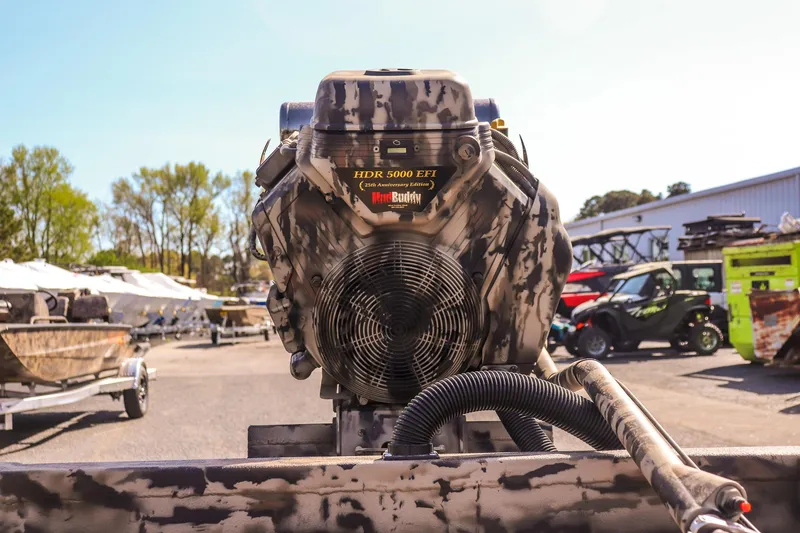 Slide: The Image of 2025 Excel 1754 F4 Shallow Water boat engine, camo design, outdoor setting. - 21