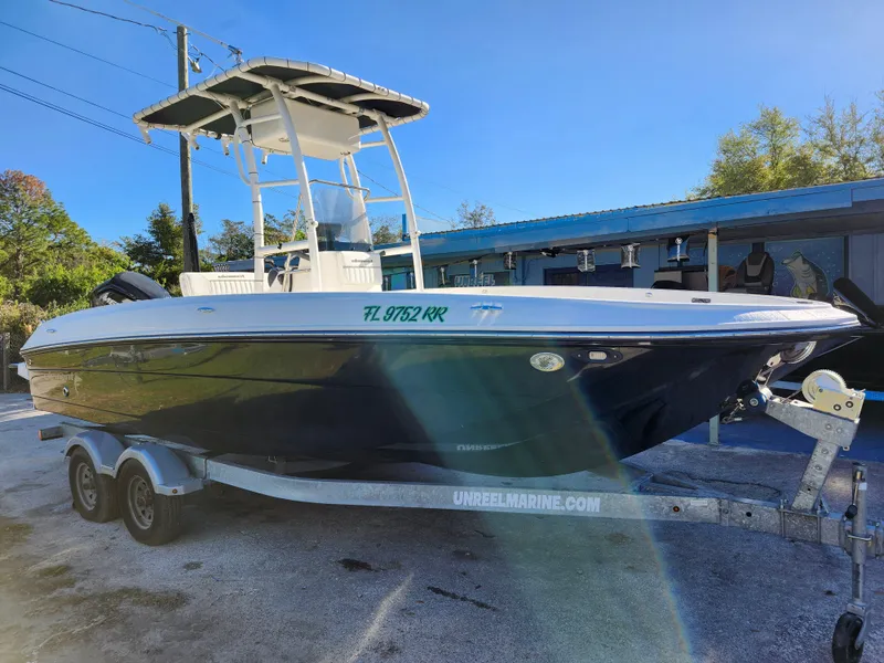 Slide: The Image of 2018 Bayliner Element F21 boat on trailer, parked outdoors. - 1