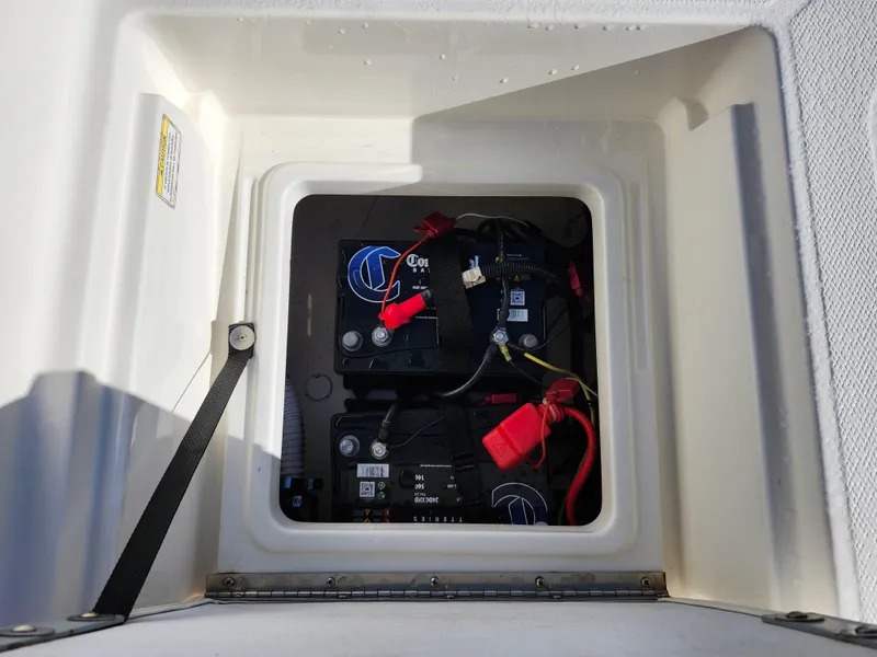 Slide: The Image of Battery compartment of 2018 Bayliner Element F21 boat with visible wiring. - 12