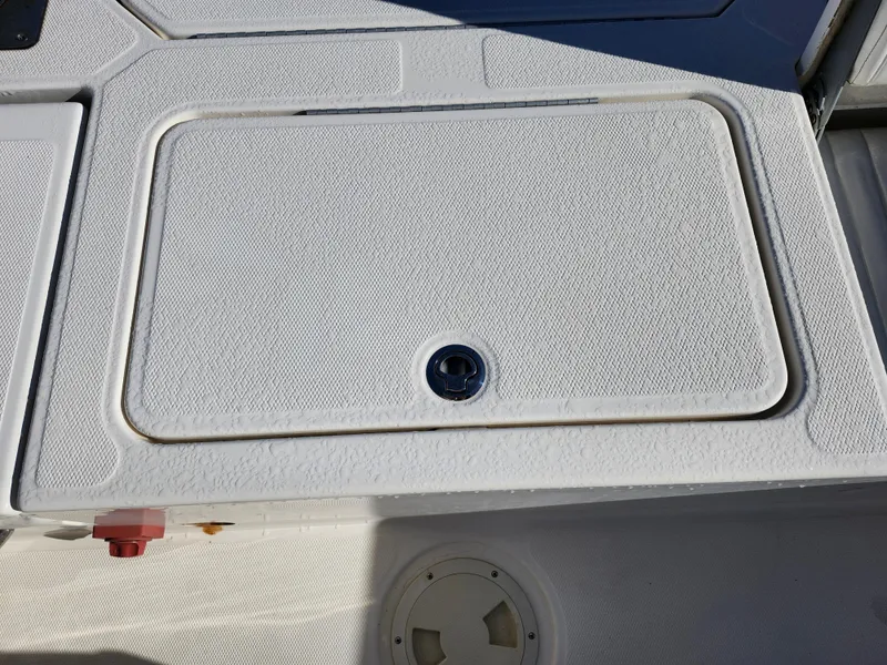 Slide: The Image of 2018 Bayliner Element F21 boat deck with storage compartment. - 13