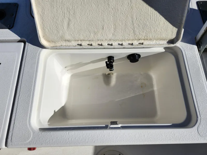 Slide: The Image of Open storage compartment on 2018 Bayliner Element F21 boat. - 14