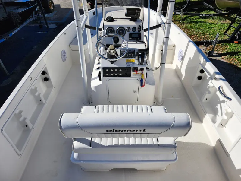 Slide: The Image of 2018 Bayliner Element F21 boat interior with steering console and seating. - 17
