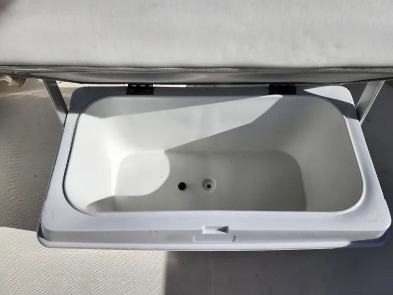 Slide: The Image of Open storage compartment on 2018 Bayliner Element F21 boat. - 19