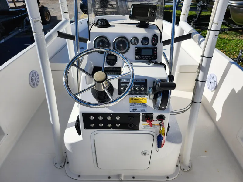 Slide: The Image of 2018 Bayliner Element F21 boat console with steering wheel and control panel. - 20