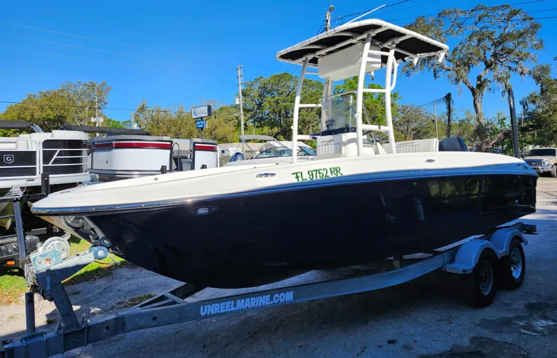 Slide: The Image of 2018 Bayliner Element F21 boat on trailer, parked outdoors. - 3