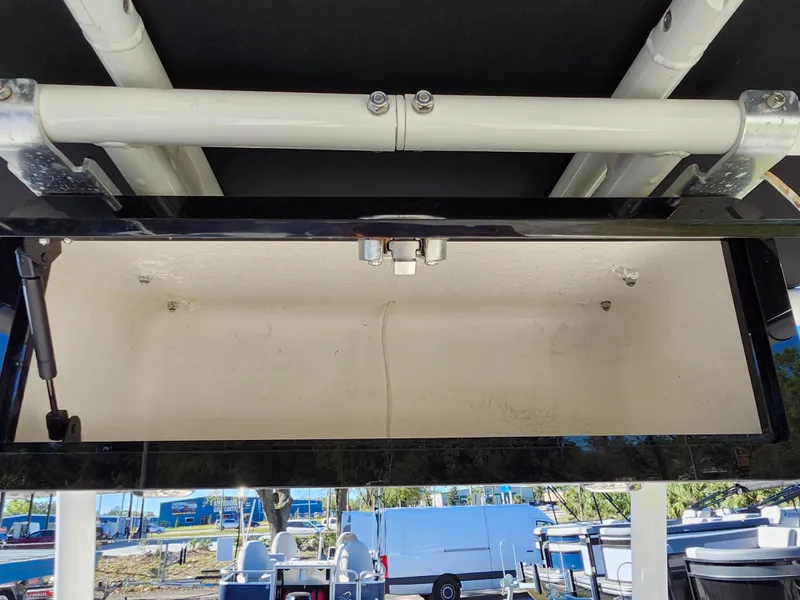 Slide: The Image of 2018 Bayliner Element F21 storage compartment, open and empty, with visible hydraulic support. - 31