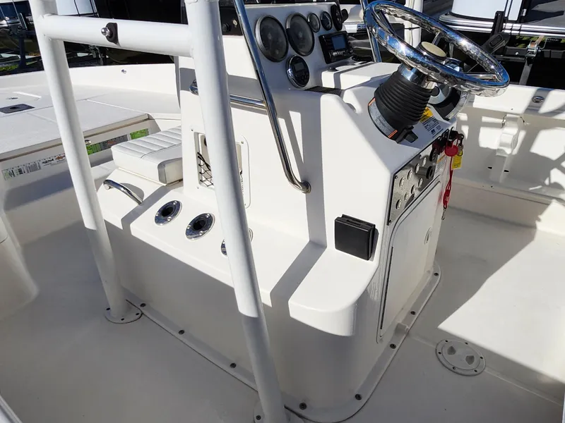 Slide: The Image of 2018 Bayliner Element F21 boat console with steering wheel and controls. - 32