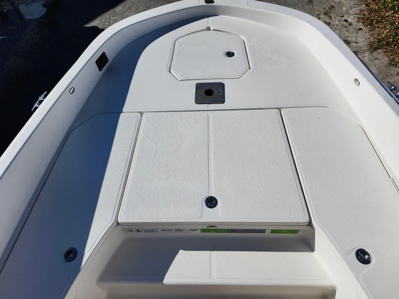 Slide: The Image of 2018 Bayliner Element F21 boat deck with storage compartments and clean white finish. - 38