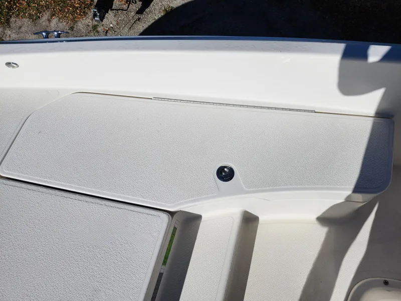 Slide: The Image of 2018 Bayliner Element F21 boat deck with textured surface and storage compartment. - 39