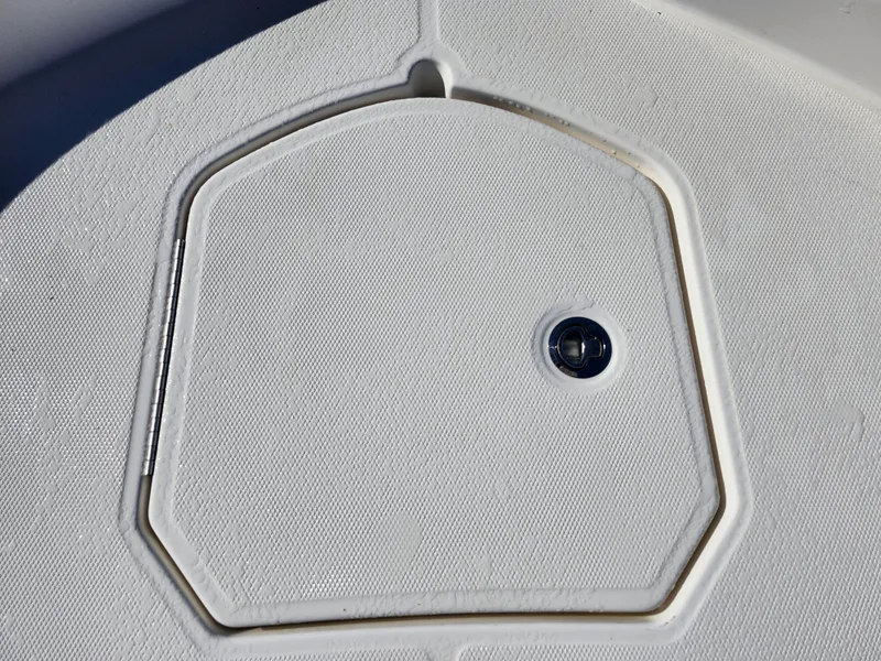Slide: The Image of 2018 Bayliner Element F21 boat hatch with textured surface and circular handle. - 45