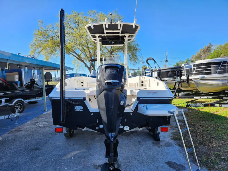 Slide: The Image of 2018 Bayliner Element F21 boat with outboard motor, parked outdoors on a sunny day. - 5