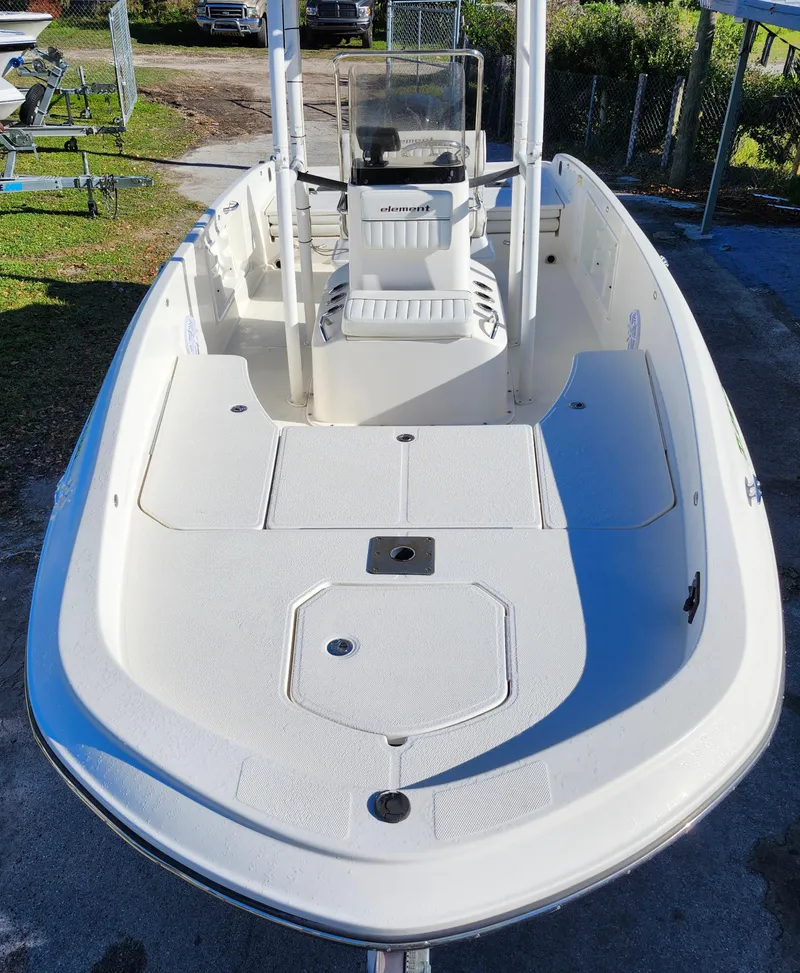 Slide: The Image of 2018 Bayliner Element F21 boat, white deck, center console, outdoor setting. - 7