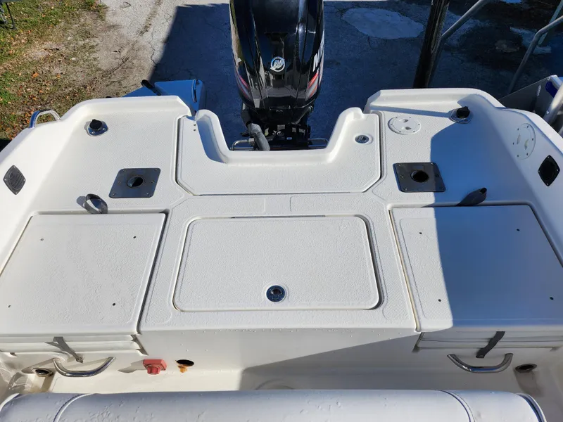Slide: The Image of 2018 Bayliner Element F21 boat deck with storage compartments and motor. - 9