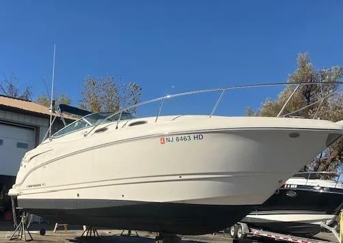 The Image of 2013 Chaparral 290 Signature boat on dry dock, side view, clear blue sky. - 0