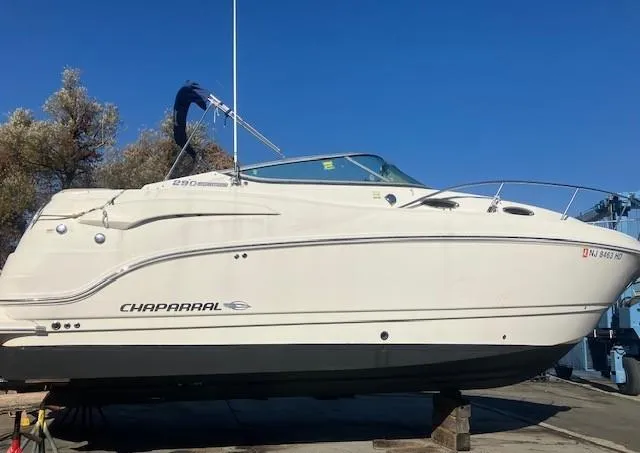 Slide: The Image of 2013 Chaparral 290 Signature boat on dry dock under clear blue sky. - 2