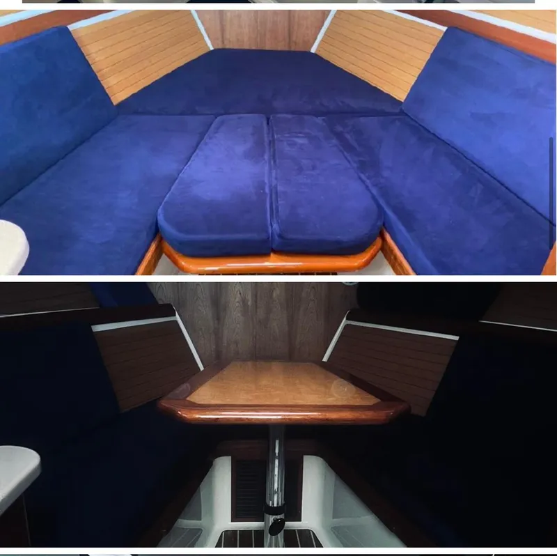 Slide: The Image of 2006 Back Cove 29 interior with blue cushions and convertible wooden table. - 2