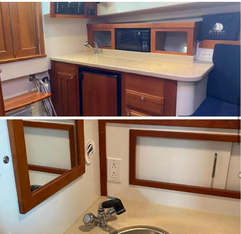 Slide: The Image of 2006 Back Cove 29 interior with kitchenette and sink, featuring wood cabinetry and modern amenities. - 4