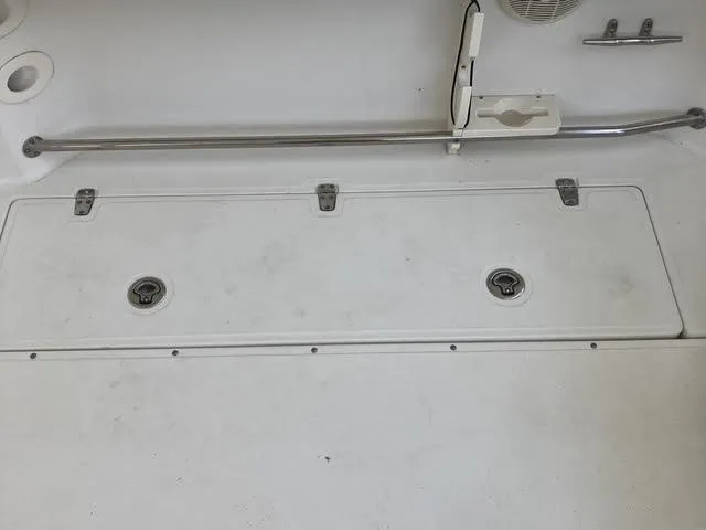 Slide: The Image of 2008 Boston Whaler 235 Conquest deck with storage hatches and stainless steel railing. - 21