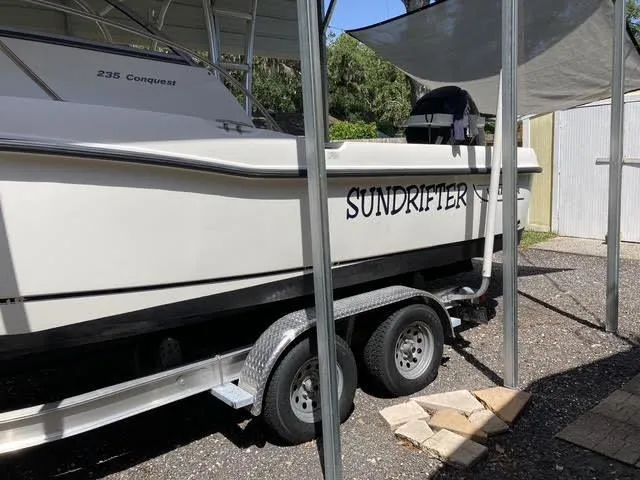 Slide: The Image of 2008 Boston Whaler 235 Conquest boat named "Sundrifter" on a trailer. - 27