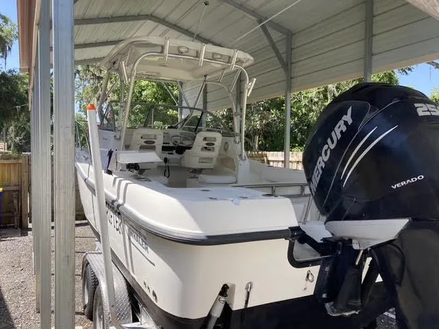 Slide: The Image of 2008 Boston Whaler 235 Conquest boat with Mercury Verado engine in covered storage. - 29