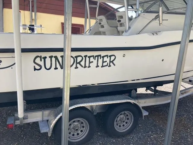 Slide: The Image of 2008 Boston Whaler 235 Conquest boat named "Sundrifter" on a trailer. - 33