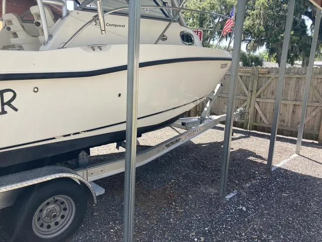 Slide: The Image of 2008 Boston Whaler 235 Conquest boat on trailer in storage area. - 34
