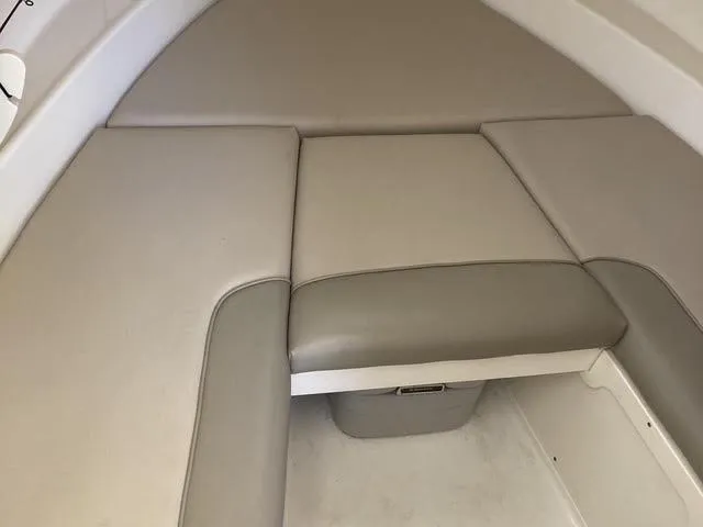 Slide: The Image of 2008 Boston Whaler 235 Conquest cabin interior with cushioned seating. - 6