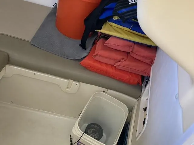 Slide: The Image of Interior of 2008 Boston Whaler 235 Conquest with life jackets and storage items. - 7