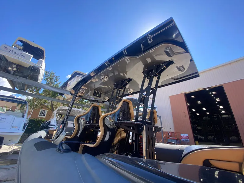 Slide: The Image of 2018 Bernico RX10 boat with sleek design and modern seating, under a clear blue sky. - 17