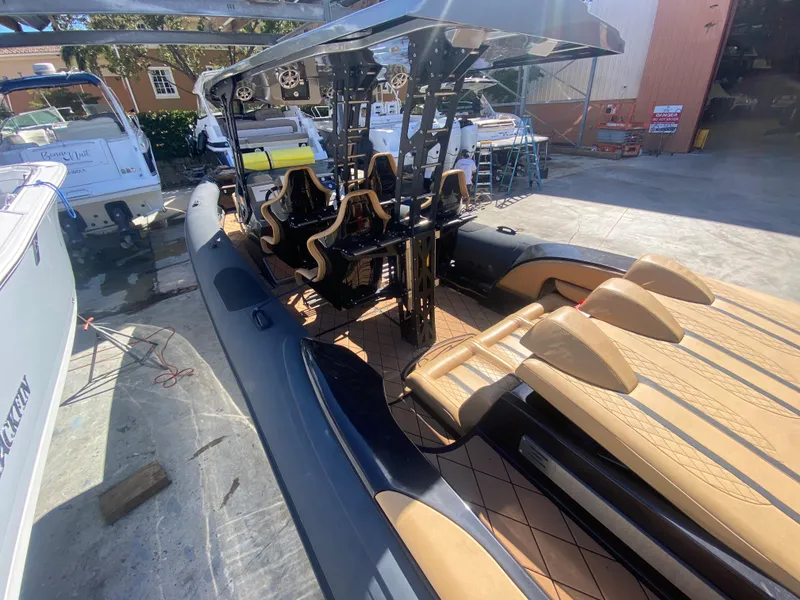 Slide: The Image of 2018 Bernico RX10 boat with sleek design and luxurious seating in a sunny marina setting. - 19
